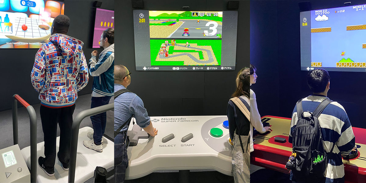Giant video game controllers being controlled by two people at the same time
