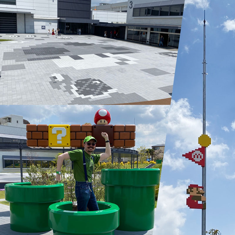 The outside part of the museum, with real-sized green pipes and the flag at the end of a stage