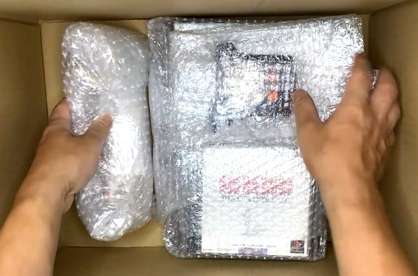 Produtos sendo cuidadosamente colocados em uma caixa